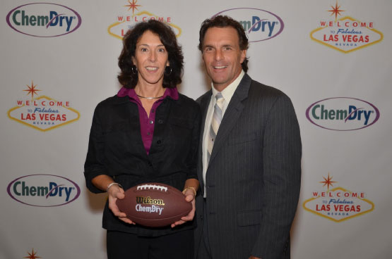 Chem-Dry owner Deb Purcell poses with football great Doug Flutie during the 2013 Chem-Dry convention in Las Vegas.